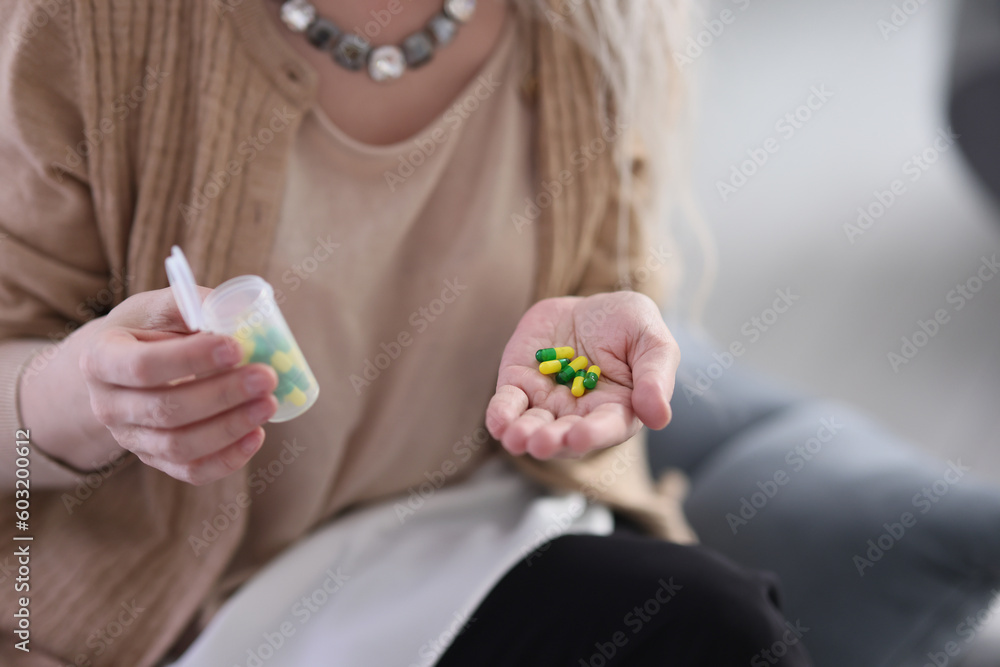 Woman holds in hand pills with vitamins to maintain body Woman holds in hand pills with vitamins to maintain body