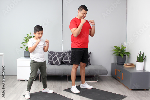Boxing classes in the living room of his house between dad and son as a student teacher teaches techniques and practices of the sport