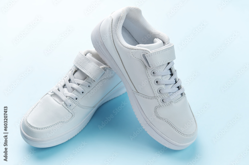 White sneakers on a blue background. White sneakers on a blue background.