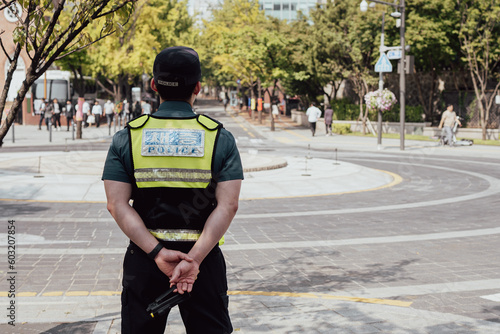 Korean police uniform standing holding radio communication in Seoul, Korea.