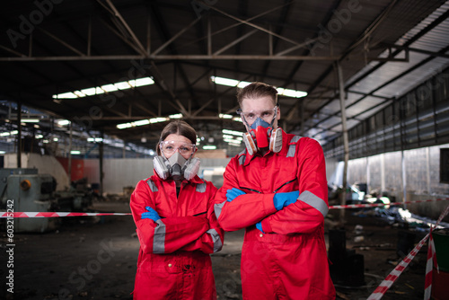 Portrait happiness industry workers with safety uniform ,blue glove and helmet to safety before start work to check chemical or gas in factory is industry safety concept.