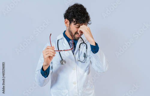 Photos Overworked doctor with eyestrain isolated