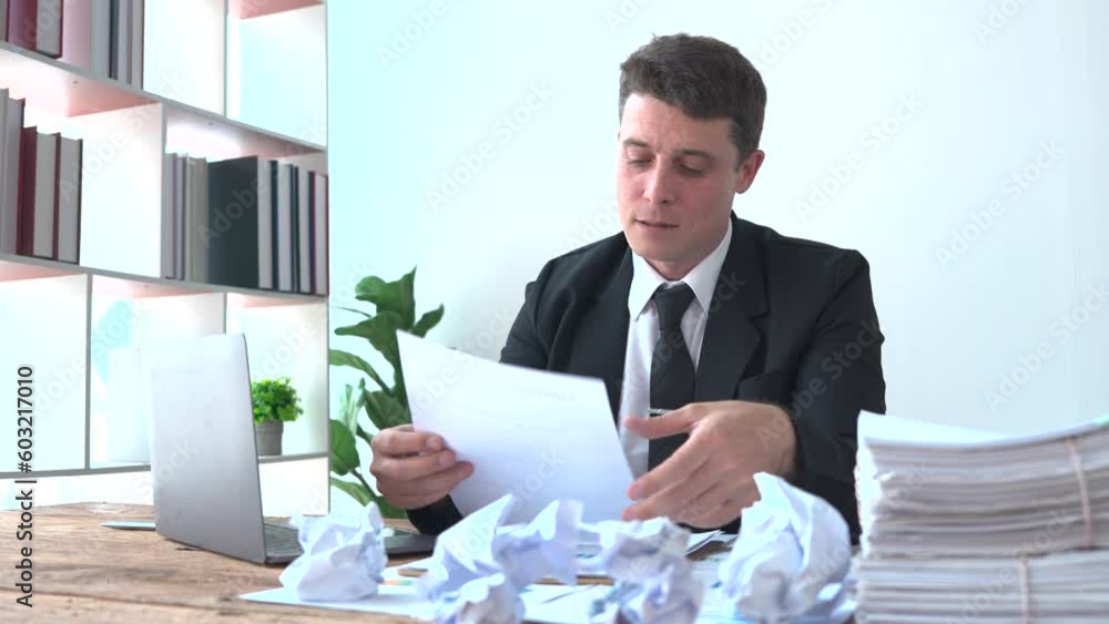 Stressed overwhelmed young businessman in working on computer, suffering from eyes fatigue or having painful feelings. Exhausted executive manager overworked in office, burnout concept
