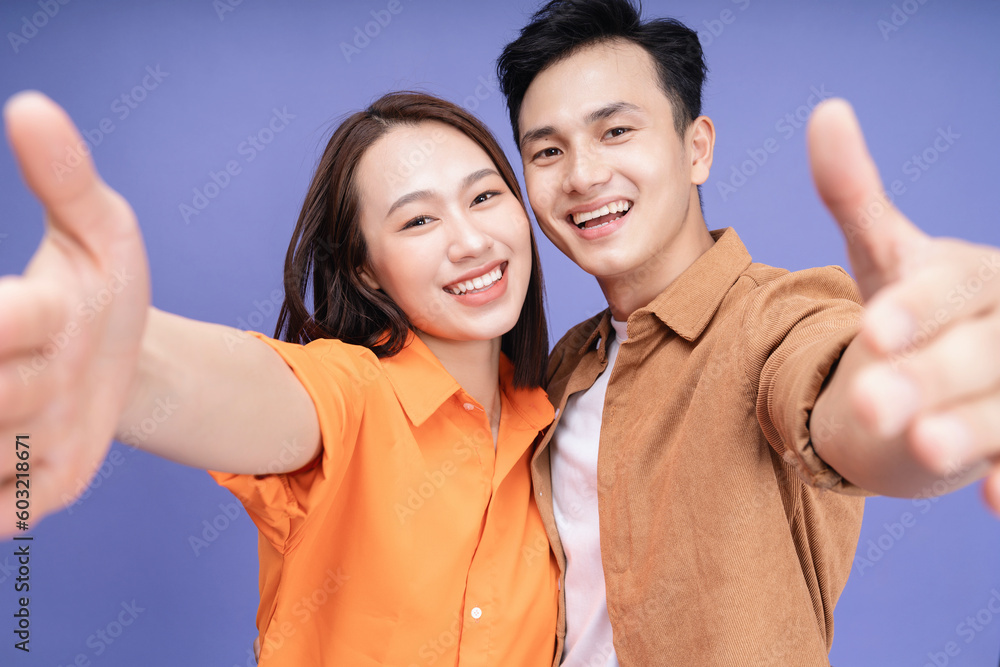 Photo of young Asian couple on background Photo of young Asian couple on background