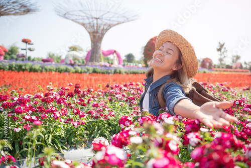 Beautiful woman enjoying flowers field, nice female lying down in meadow of flowers, pretty girl relaxing outdoor, having fun, happy young lady and spring green nature, Freedom concept.