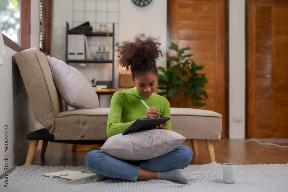 Cute young woman using tablet entertainment relaxing at home. Beautiful young black women using tablet computer at home. Cute young woman using tablet entertainment relaxing at home. Beautiful young black women using tablet computer at home.