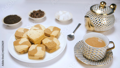 Obraz na plátne Elegant table decoration with designer tea-set  a plate of cookies  and sugar cubes