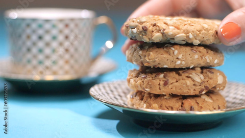 Photos Woman slowly keeps a multi-grain cookie on top of other cookies