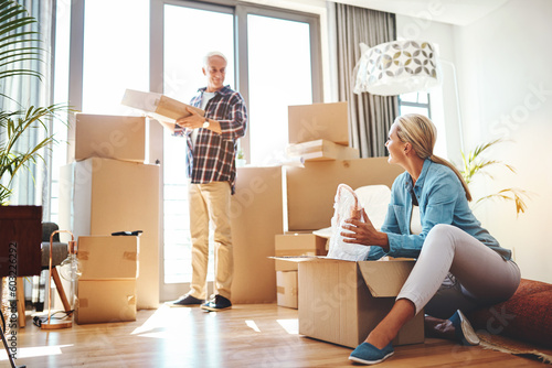 Obraz na plátne Real estate, property and a senior couple moving house while packing boxes together in their home