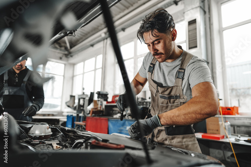 Two male mechanics repairing car in car service © fotofabrika