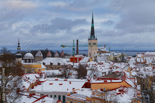 TALLINN, ESTONIA - JAN 15, 2023: Snow-covered roofs of houses in old town of Tallinn after snowfall