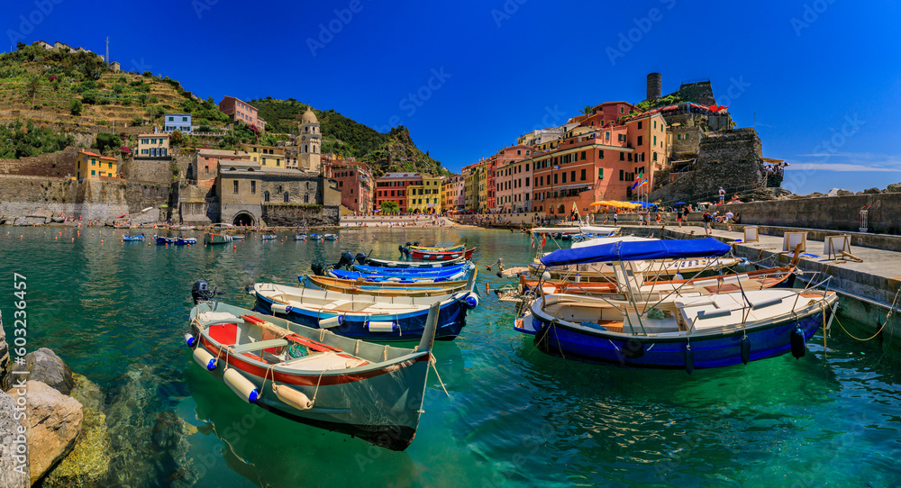 Mediterranean Sea with colorful boats and houses in Vernazza, Cinque Terre Italy