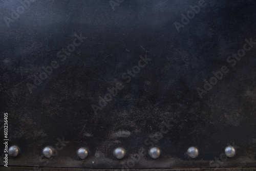 Metal rivets in a row on the scratched surface of the leather material. Overlay for your design with space to copy. High quality photo