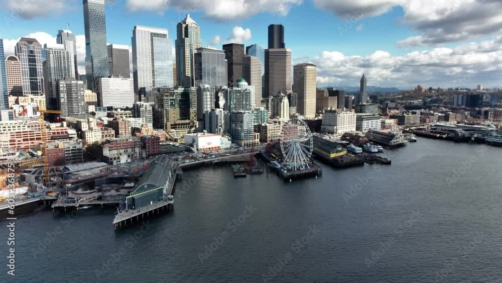 Establishing aerial view towards Seattle Elliot bay waterfront great Ferris wheel and business district skyscraper skyline Establishing aerial view towards Seattle Elliot bay waterfront great Ferris wheel and business district skyscraper skyline