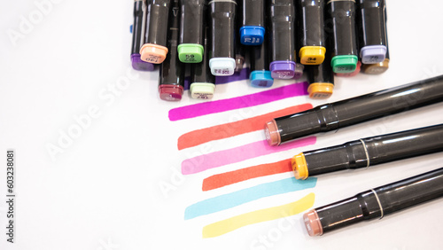 Colorful marker pens on white background with copy space for text.