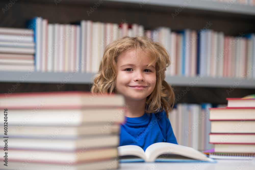 Kid reads books in the library. Schoolboy with book in school library. Literature for reading. Child learning from books. School education and clever talented pupil genius. Kid reads books in the library. Schoolboy with book in school library. Literature for reading. Child learning from books. School education and clever talented pupil genius.