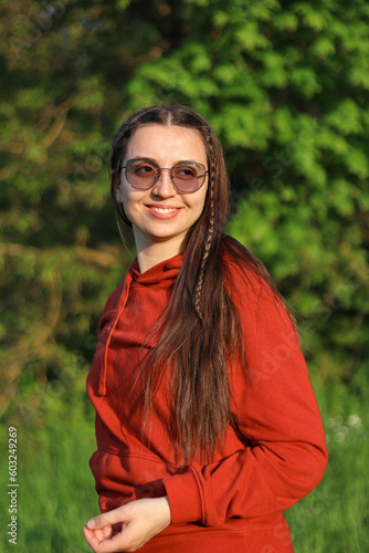 Woman in the forest.Portrait of a brunette.Photo of a girl in nature. Beautiful portrait. Woman posing in the forest.Romantic young woman.Girl in red.Beautiful long hair.happy girl.emotions.smile.