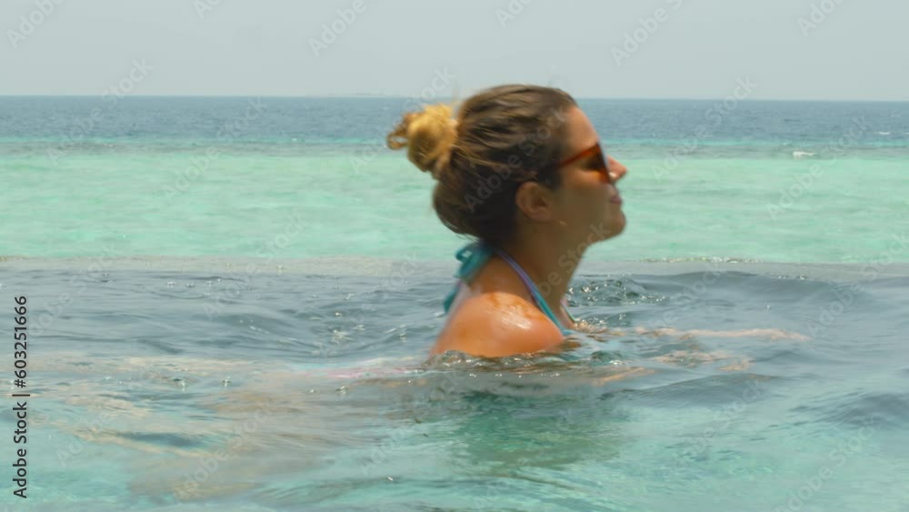 Woman swimming in luxury vacation resort Woman swimming in luxury vacation resort
