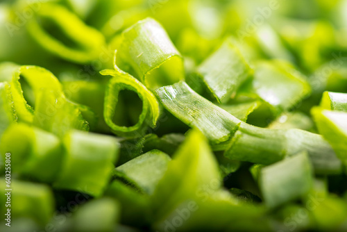 chopped green onions. Eds background is a green onion. Green Perya onion cut for freezing. Background from the cut bow