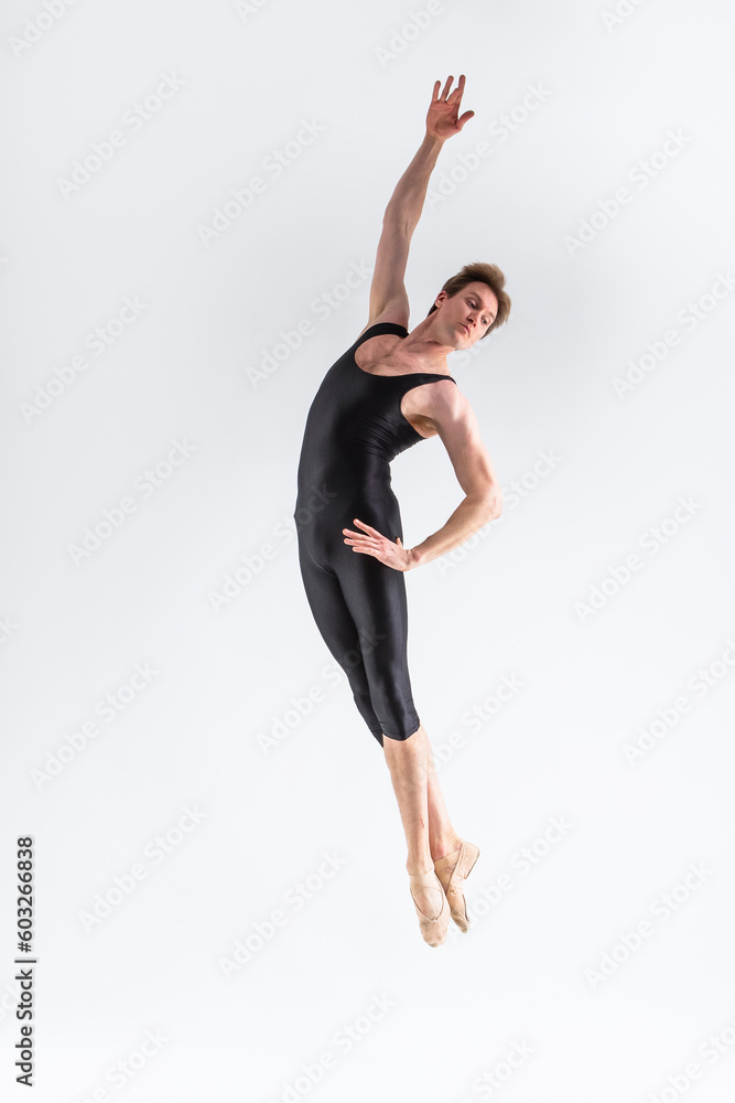 Fototapeta premium Ballet Dance Concepts. Contemporary Art Ballet With Young Handsome Caucasian Dancing Athletic Man In Studio On White