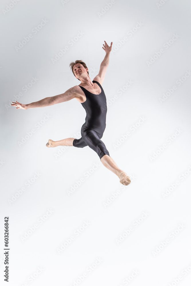 Professional Ballet Dancer Young Caucasian Athletic Man in Black Suit Dancing in Studio On White Background