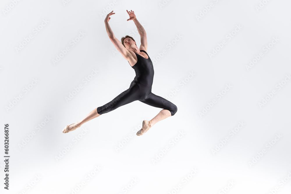 Ballet Dancer Young Caucasian Athletic Man in Black Suit Posing Dancing in Studio On White.