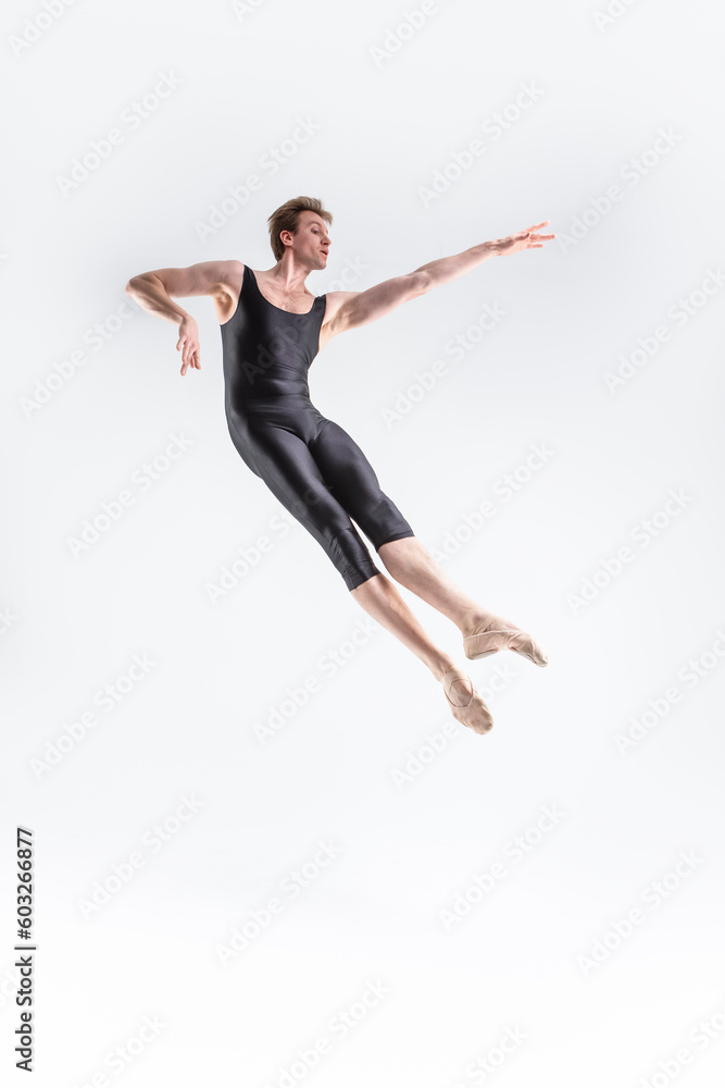Caucasian Ballet Dancer Young Caucasian Athletic Man in Black Suit Posing Flying Dancing in Studio On White.