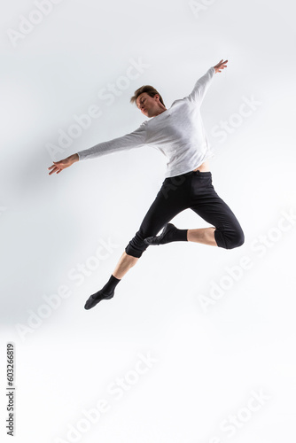 Athletic Modern Ballet Dancer. Contemporary Art Ballet With Young Flexible Athletic Man In Studio On White Background.