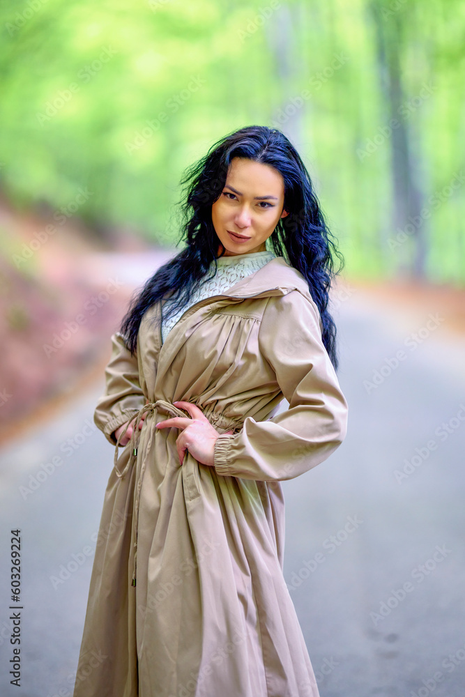 portrait of a brunette woman on a road among the trees portrait of a brunette woman on a road among the trees
