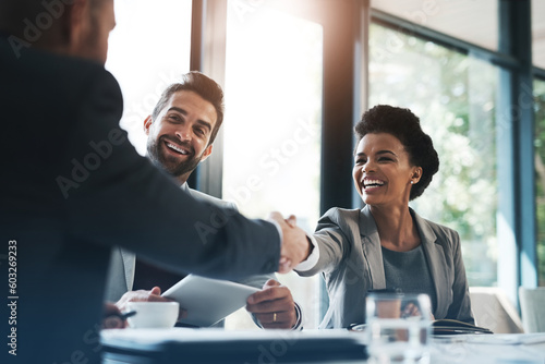 Happy business people, handshake and meeting in teamwork for partnership or collaboration in boardroom. Woman person shaking hands in team recruiting, introduction or b2b agreement at the workplace photo