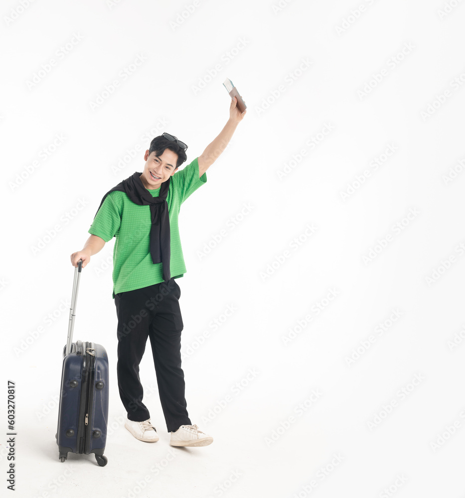 Happy young Asian man tourist man holding passport and plane ticket, make peace sign joyful with baggage going to travel on holidays isolated on white copy space background Happy young Asian man tourist man holding passport and plane ticket, make peace sign joyful with baggage going to travel on holidays isolated on white copy space background