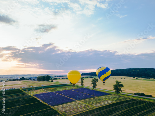 air balloon with basket above lavender field