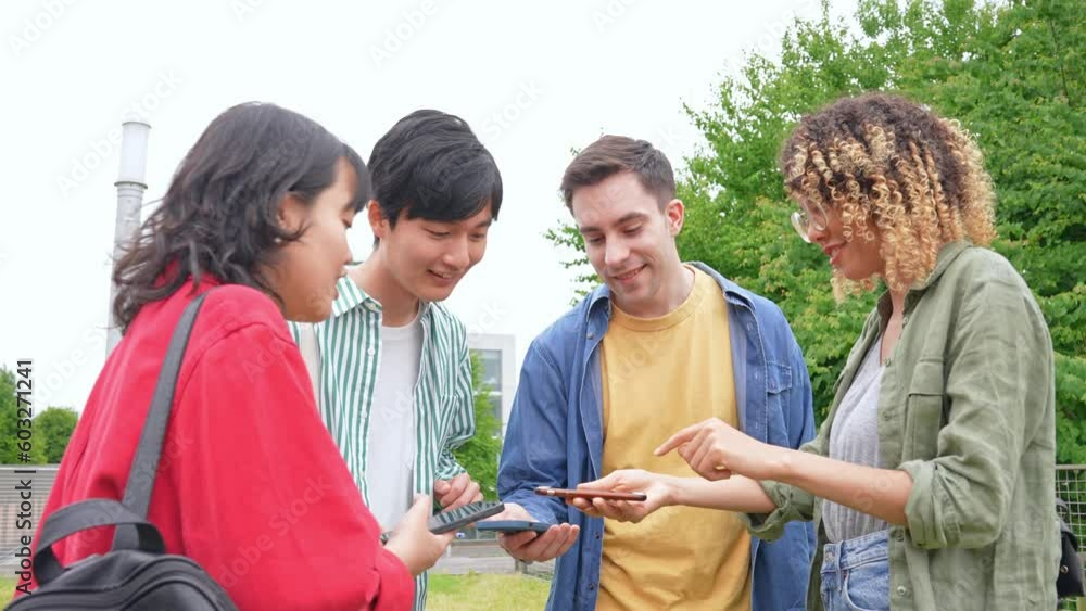 Multinational youth group using smart phone in campus of university. Multinational youth group using smart phone in campus of university.