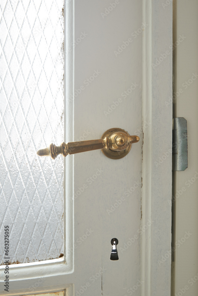 Copper metal door handel on white wooden door Copper metal door handel on white wooden door