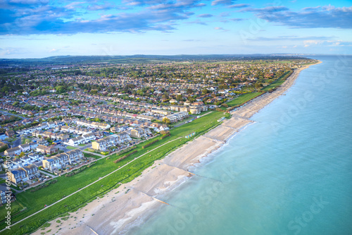Aerial photo of Rustington Village in West Sussex on the seafront by Broadmark Lane looking towards East Preston.