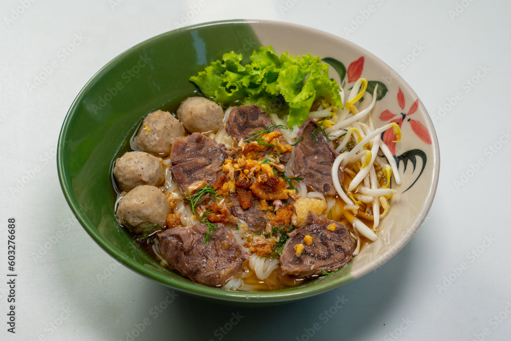 asian noodle soup with beef meatball with fresh vegetable on wood table vintage style, street food, hot and spicy noodle soup asian noodle soup with beef meatball with fresh vegetable on wood table vintage style, street food, hot and spicy noodle soup