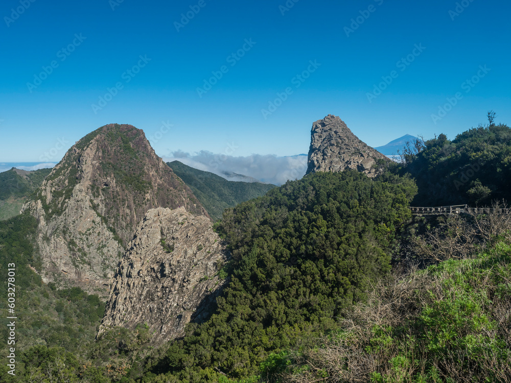 Naklejka premium Scenic view from the Mirador del Bailadero with volcanic rock formations Los Roques and island Tenerife and Volcano Pico de Teide. Garajonay National Park on La Gomera, Canary Islands, Spain, Europe.