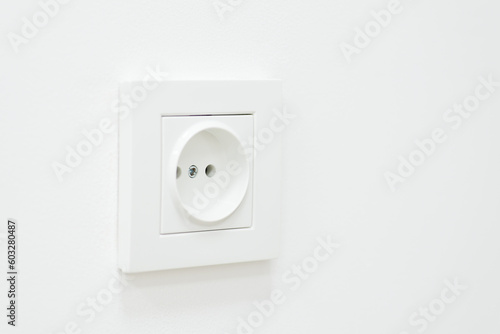 Close up of an empty socket on a white wall. Electricity concept, white outlet