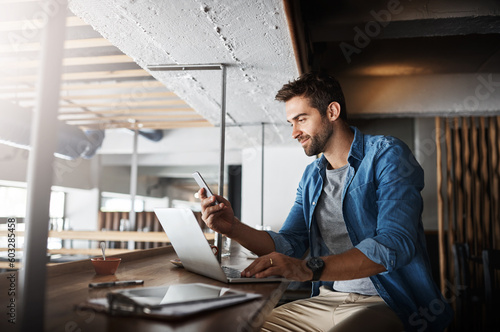 Man in coffee shop, laptop and smartphone, small business and entrepreneur in hospitality industry and connect. Male owner, cafe franchise and check email or social media with digital admin on pc