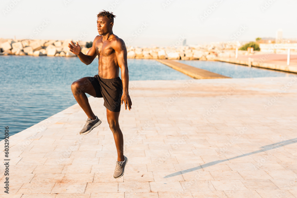 Fitness training outdoors. Handsome African man doing exercises outside. Muscular man tarining.