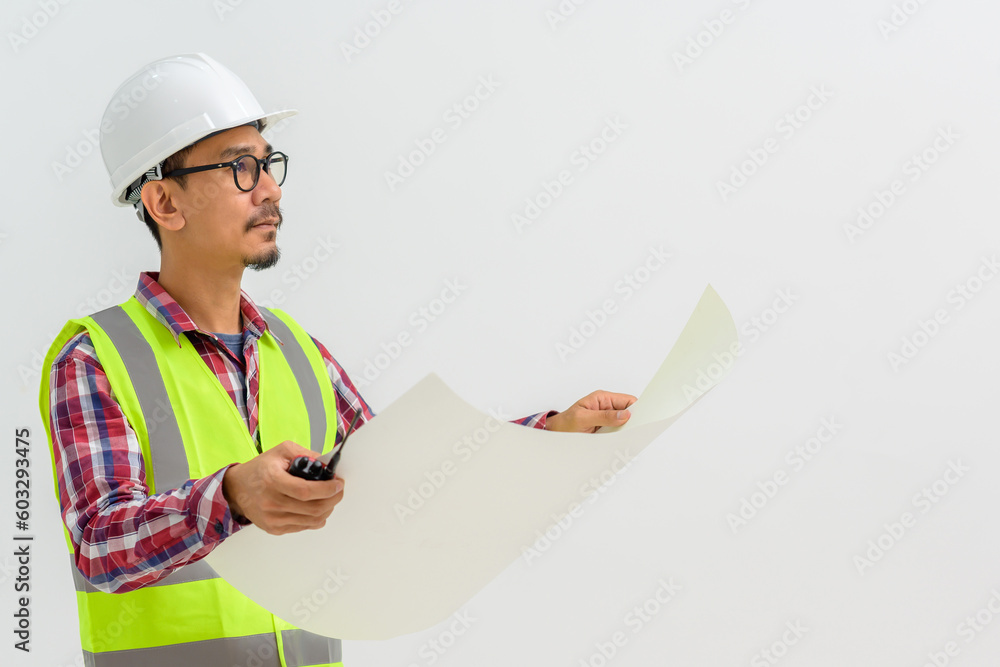 Asian young male architect Hold engineering and architecture blueprints. isolated on white background Copy space over a white studio background. Asian young male architect Hold engineering and architecture blueprints. isolated on white background Copy space over a white studio background.