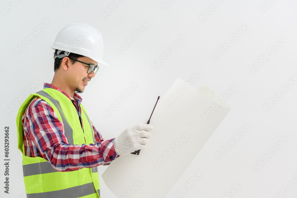Asian handsome young male architect engineer looking at blueprints Engineering and architecture concept isolated on white background. Copy Space Posing Over White Studio Background Asian handsome young male architect engineer looking at blueprints Engineering and architecture concept isolated on white background. Copy Space Posing Over White Studio Background