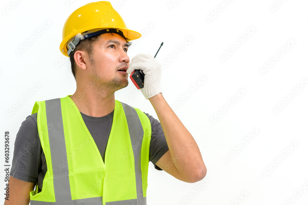 Portrait of male construction worker wearing hard hat holding construction walkie talkie isolated on white background Copy space over a white studio background. Portrait of male construction worker wearing hard hat holding construction walkie talkie isolated on white background Copy space over a white studio background.