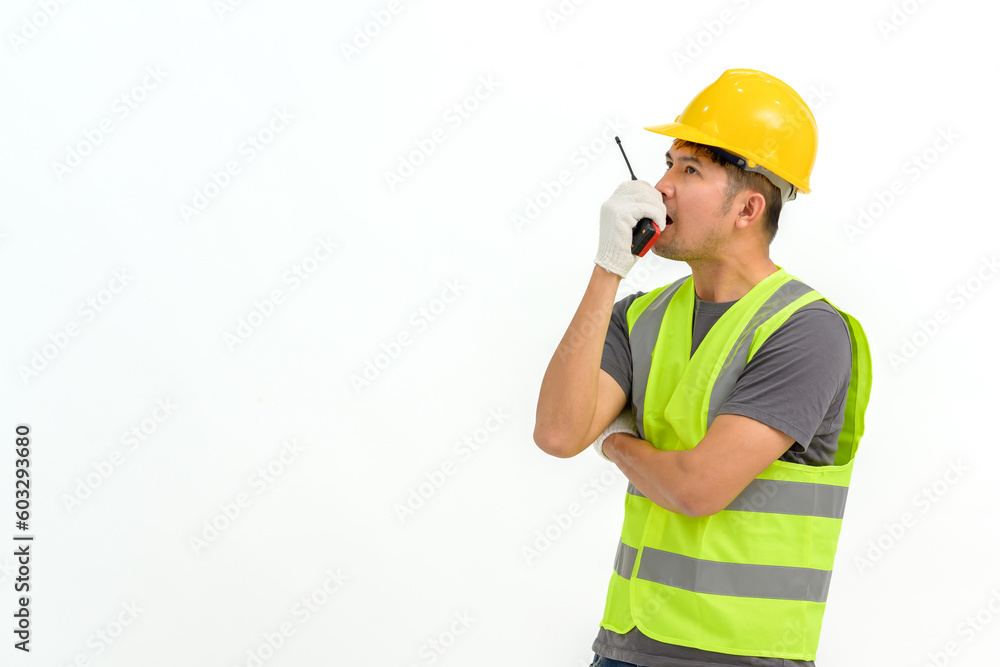 Portrait of male construction worker wearing hard hat holding construction walkie talkie isolated on white background Copy space over a white studio background.