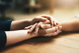 Holding hands, comfort and support of friends, care and empathy together on table in home mockup. Kindness, love and women hold hand for hope, trust or prayer, solidarity or compassion, help or unity