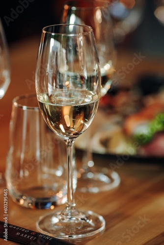 glass of dry White wine ripe grapes and bread on table in vineyard