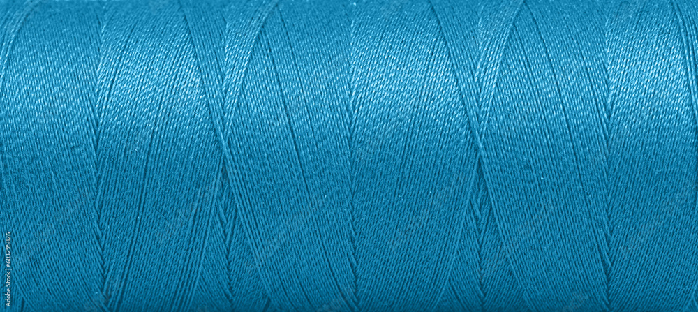 Texture of threads in a spool of blue color on a white background Texture of threads in a spool of blue color on a white background