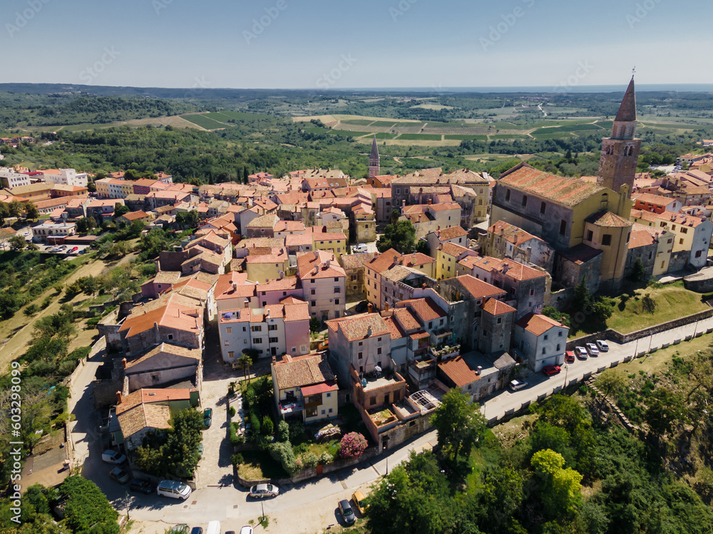 Aerial view of the beautiful medieval city of Buje in Istria, Croatia. Aerial panoramic shot on a sunny summer afternoon.