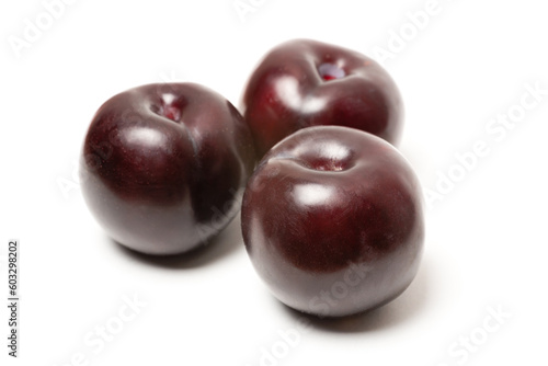 several fresh ripe plum on a white background