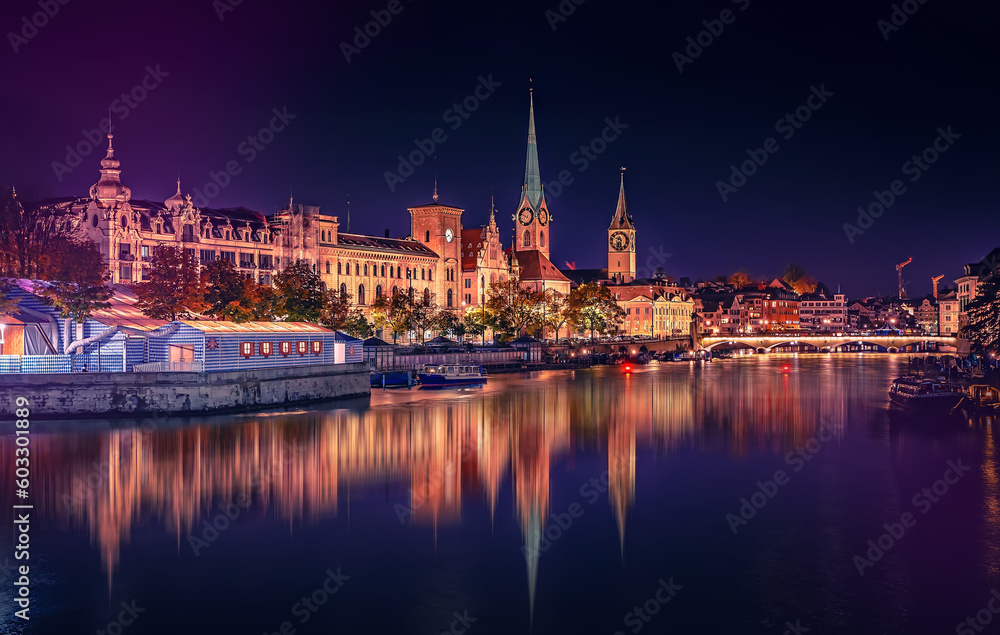 Evening panoramic view of historic Zurich city center with famous Fraumunster and river Limmat at Lake Zurich. Cityscape image of Zurich with reflection. Switzerland